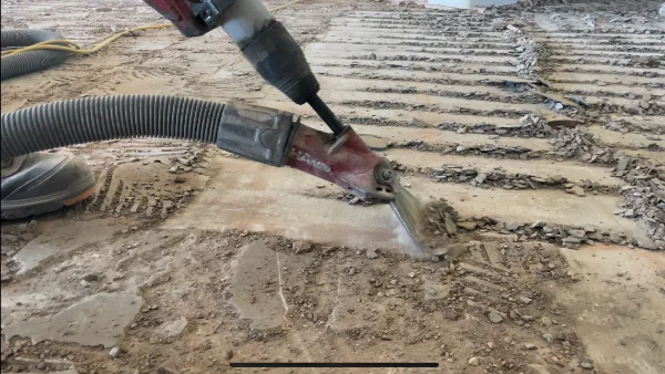Notice the dust from the tile removal quickly being sucked away by our Industrial grade HEPA vacuums.